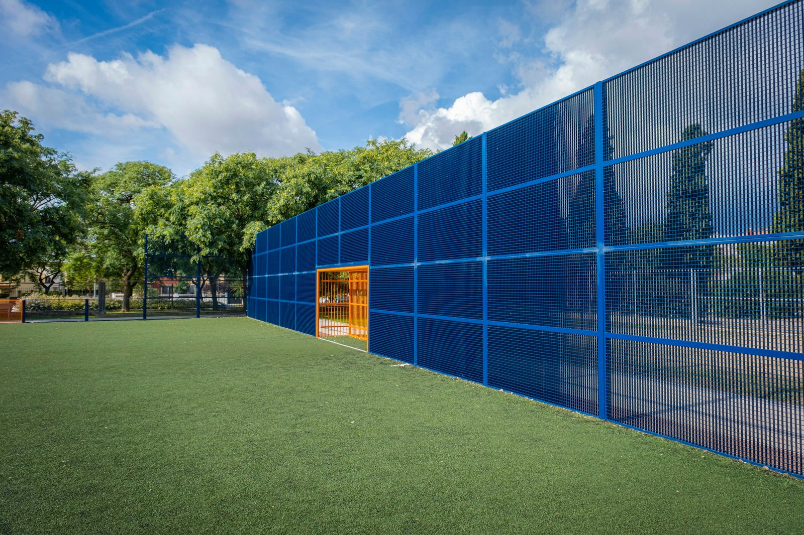 Urban soccer field with artificial turf with orange goal