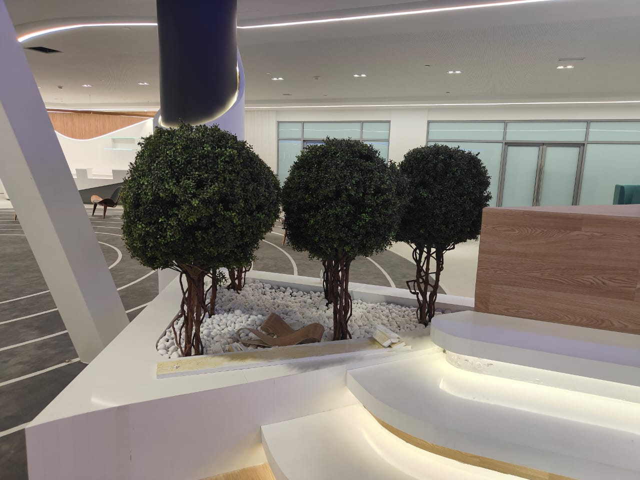 Artificial boxwood tree displayed in a decorative interior setting