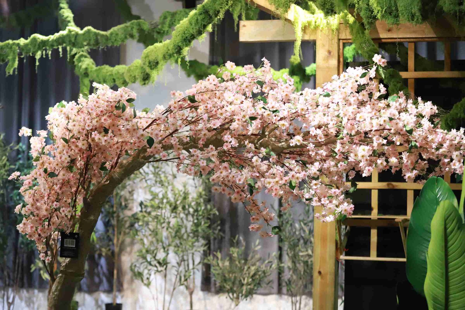 Large artificial cherry blossom tree installed in a commercial interior