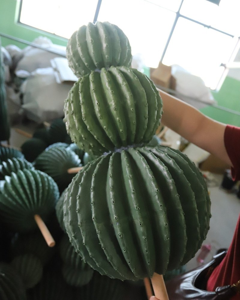Artificial cactus sphere under quality inspection in factory
