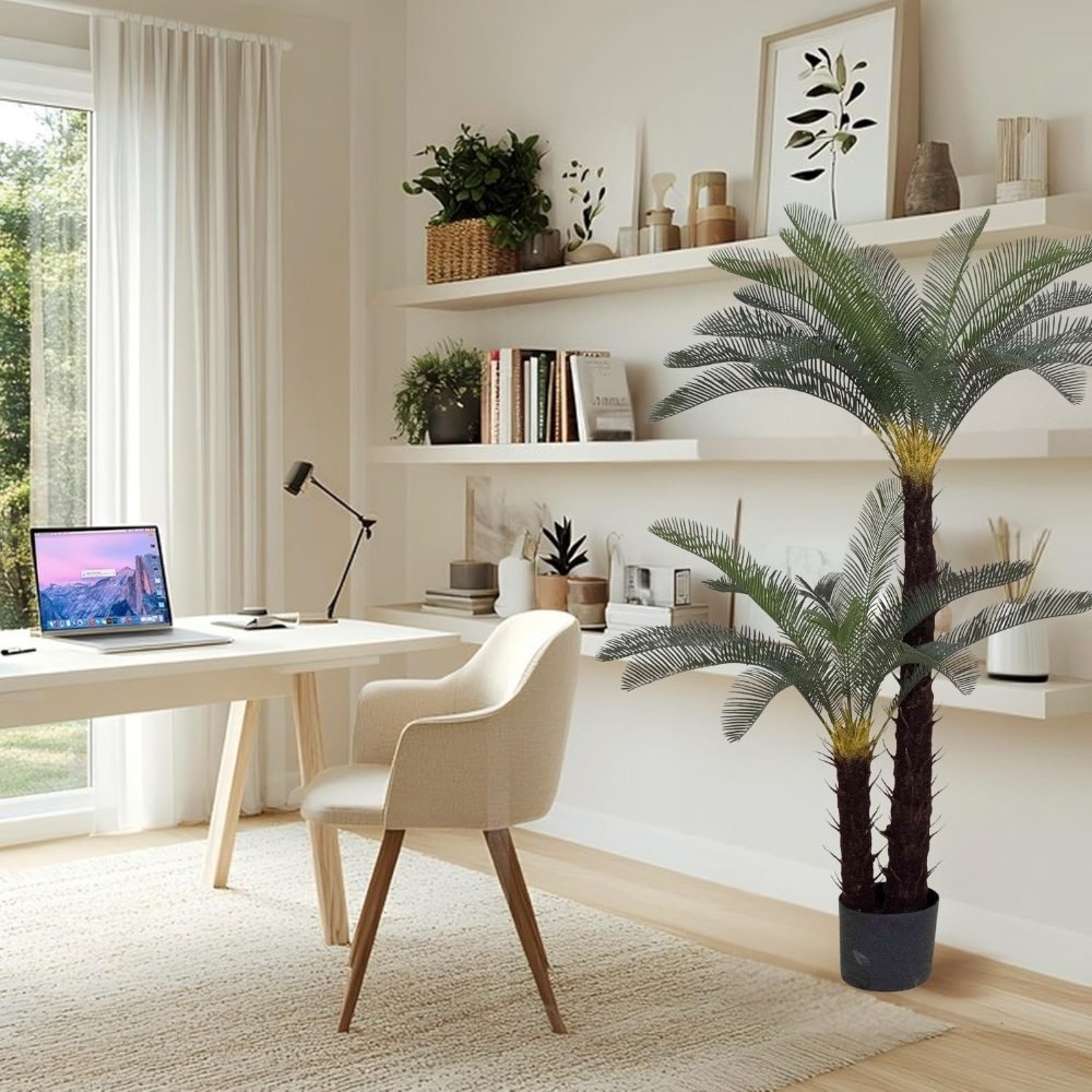 Fake sago palm tree in a white pot decorating a bright home office space