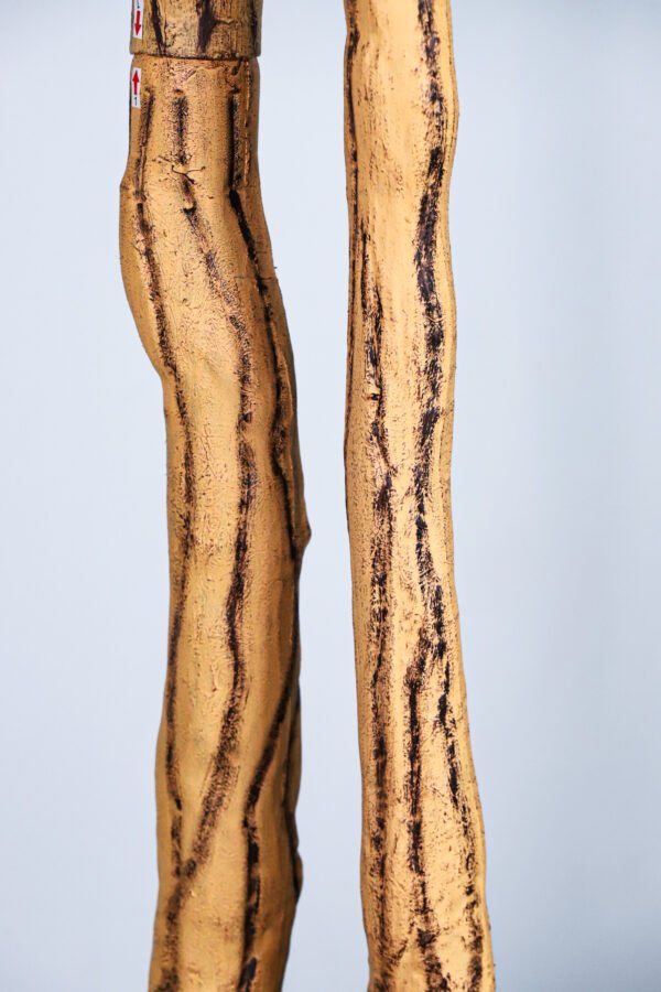 the beautifully textured and twisted faux tree trunk, showcasing its realistic wood grain and color.