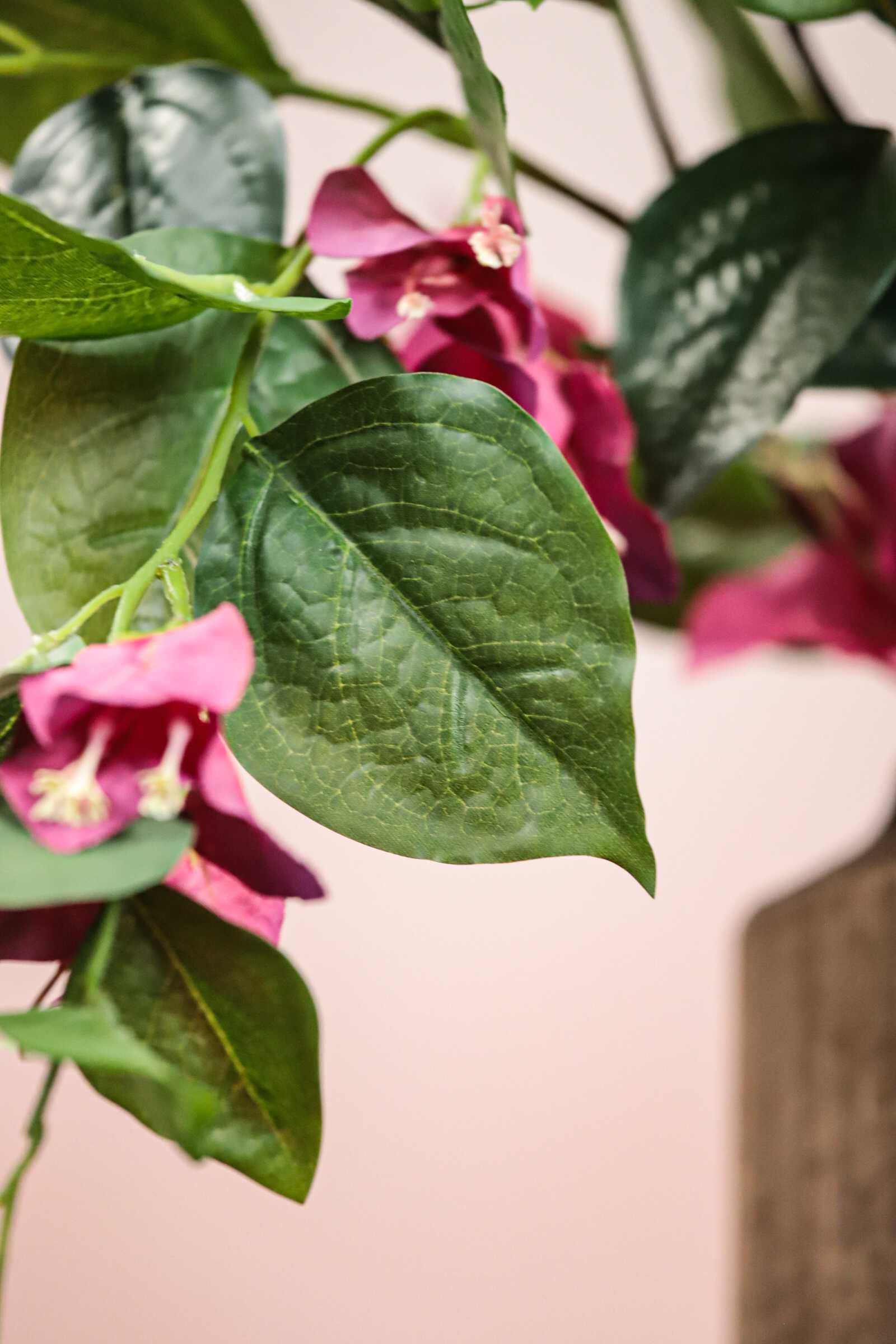 Lush pink artificial bougainvillea branch, high-density floral tree components for commercial ceiling decoration.