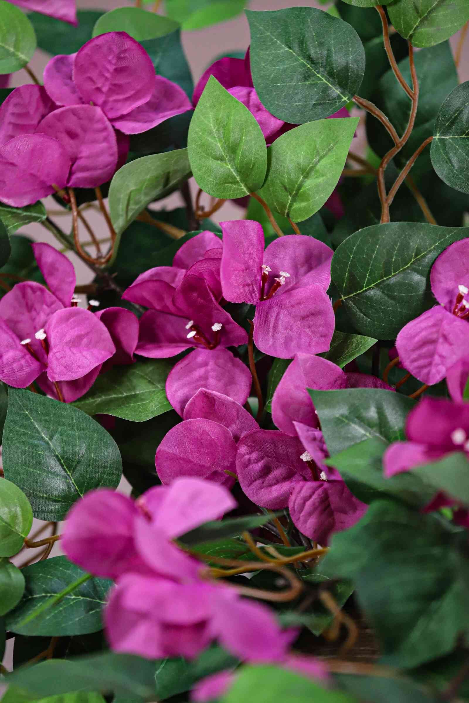 Lush pink artificial bougainvillea branch, high-density floral tree components for commercial ceiling decoration.