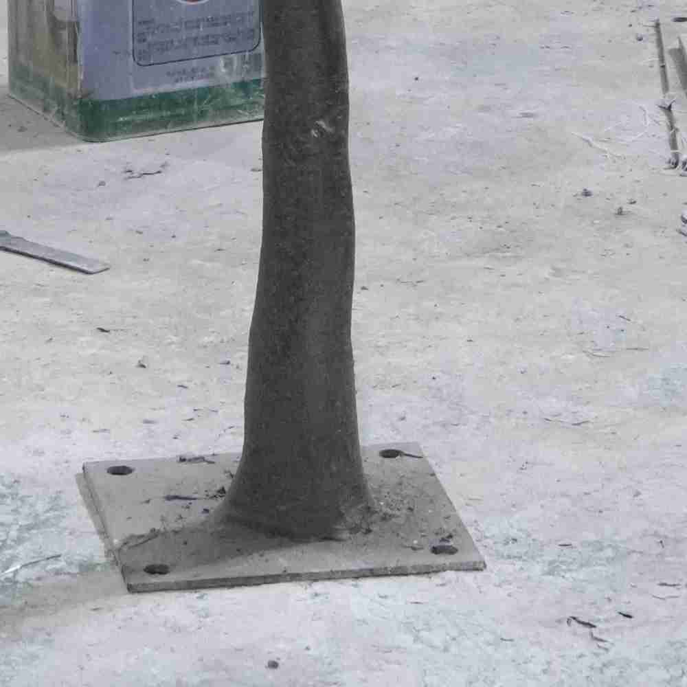 Detail of the Oakco sturdy metal base plate designed for maximum stability of large artificial trees.