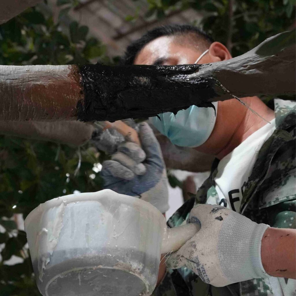 Fiberglass reinforcement process on an artificial banyan tree branch for improved durability and structural connection