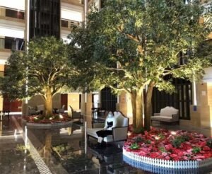 Artificial banyan trees installed in a hotel lobby to create a premium indoor focal point with realistic canopy spread