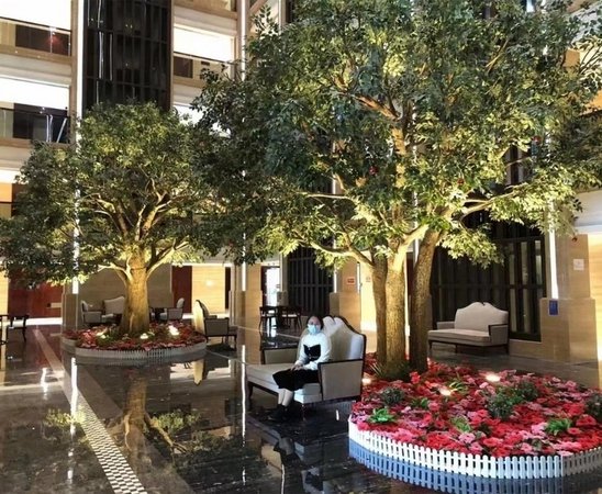 Artificial banyan trees installed in a hotel lobby to create a premium indoor focal point with realistic canopy spread