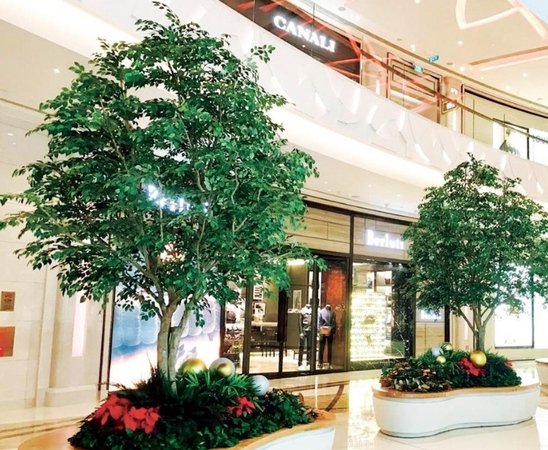 Artificial banyan trees used in a mall atrium installation to create a large low-maintenance commercial focal point
