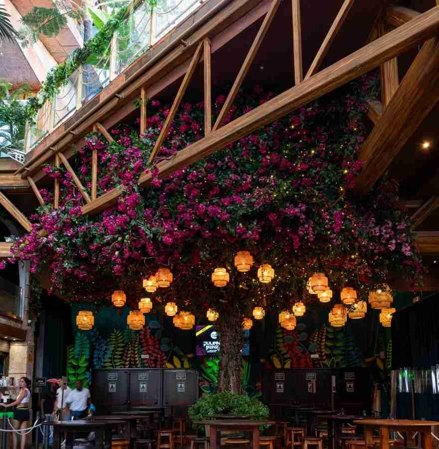artificial flowering trees used in restaurant commercial interior design project, immersive greenery installation enhancing dining atmosphere and customer experience