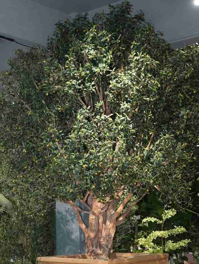 Large artificial olive tree with dense foliage, designed for indoor commercial decoration such as hotels and shopping malls