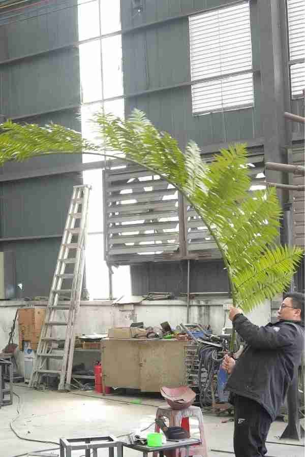 Quality control: Testing the flexibility and resilience of Oakco artificial foliage.