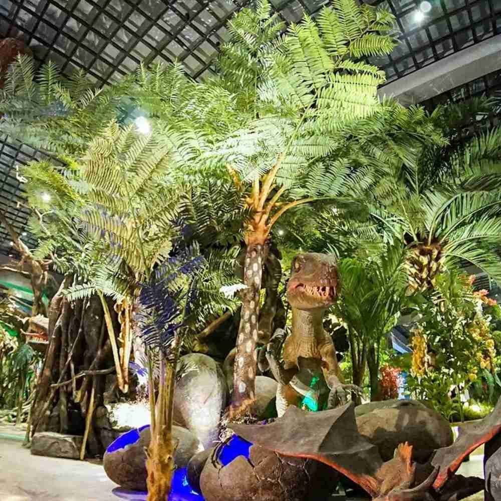 Oakco artificial fern trees used in a Jurassic-themed exhibition for a realistic prehistoric rainforest look.