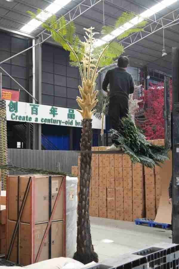 Oakco engineers conducting structural and balance tests on a large artificial tree.