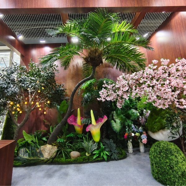 Custom artificial palm tree with tropical plants and pink blossoms for indoor commercial landscape decoration