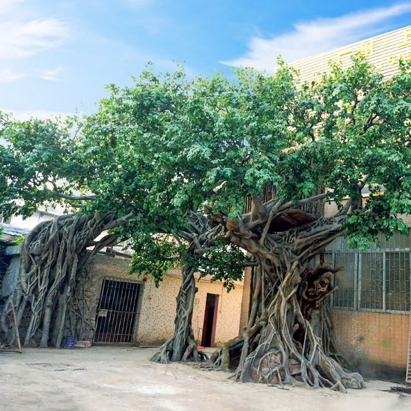 Large cement artificial tree sculpture with integrated trunk and root forms for a fixed outdoor project