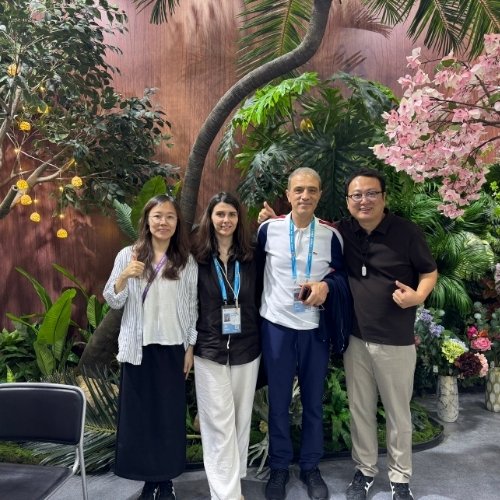 Oakco team meeting global clients at the 2026 trade show with artificial landscape products on display