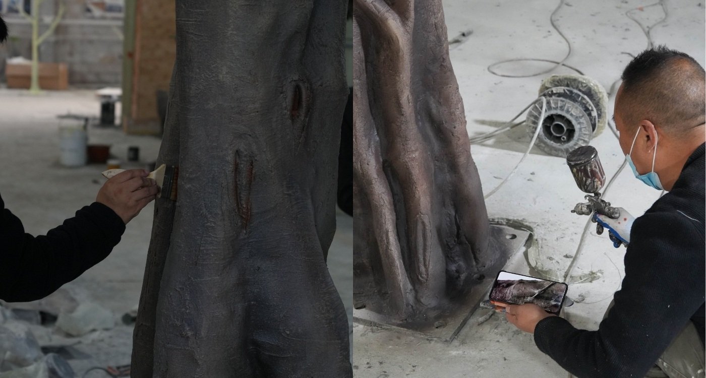 Hand-applied bark color finishing on an artificial banyan tree trunk