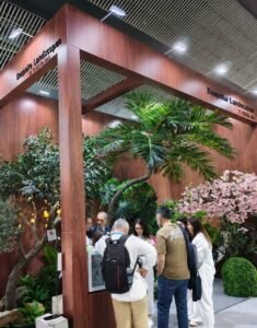 International customers visiting Oakco artificial tree and landscaping booth at a trade show