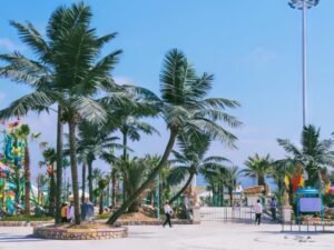 Outdoor artificial palm trees installed in a water park landscape area for sun-exposed commercial use