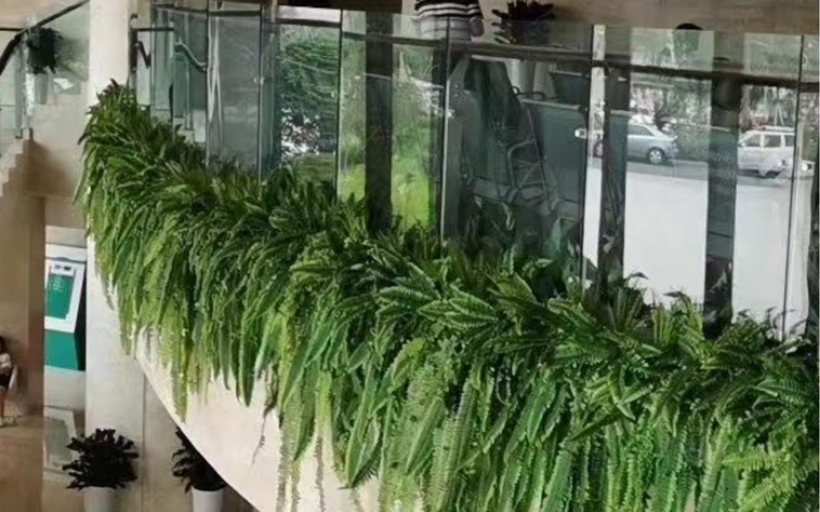 HelioLeaf UV-resistant artificial hanging plants in atrium for long-term commercial foliage installations