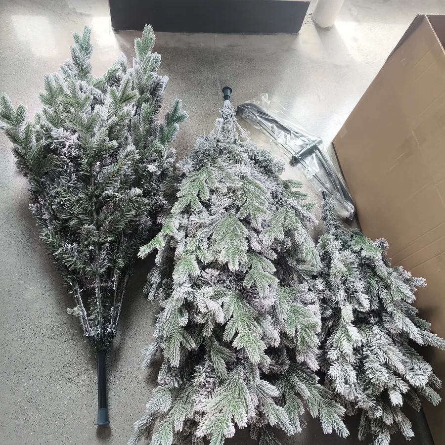 Artificial Christmas trees checked before packing