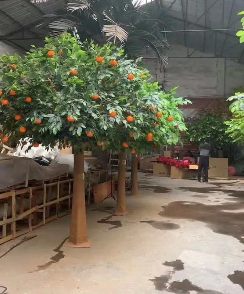 Multiple 2 to 3 metre commercial artificial orange trees ready for delivery
