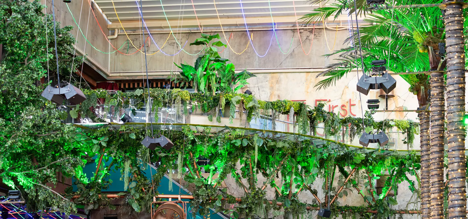 Artificial ceiling greenery and hanging plants installed in a commercial hospitality interior
