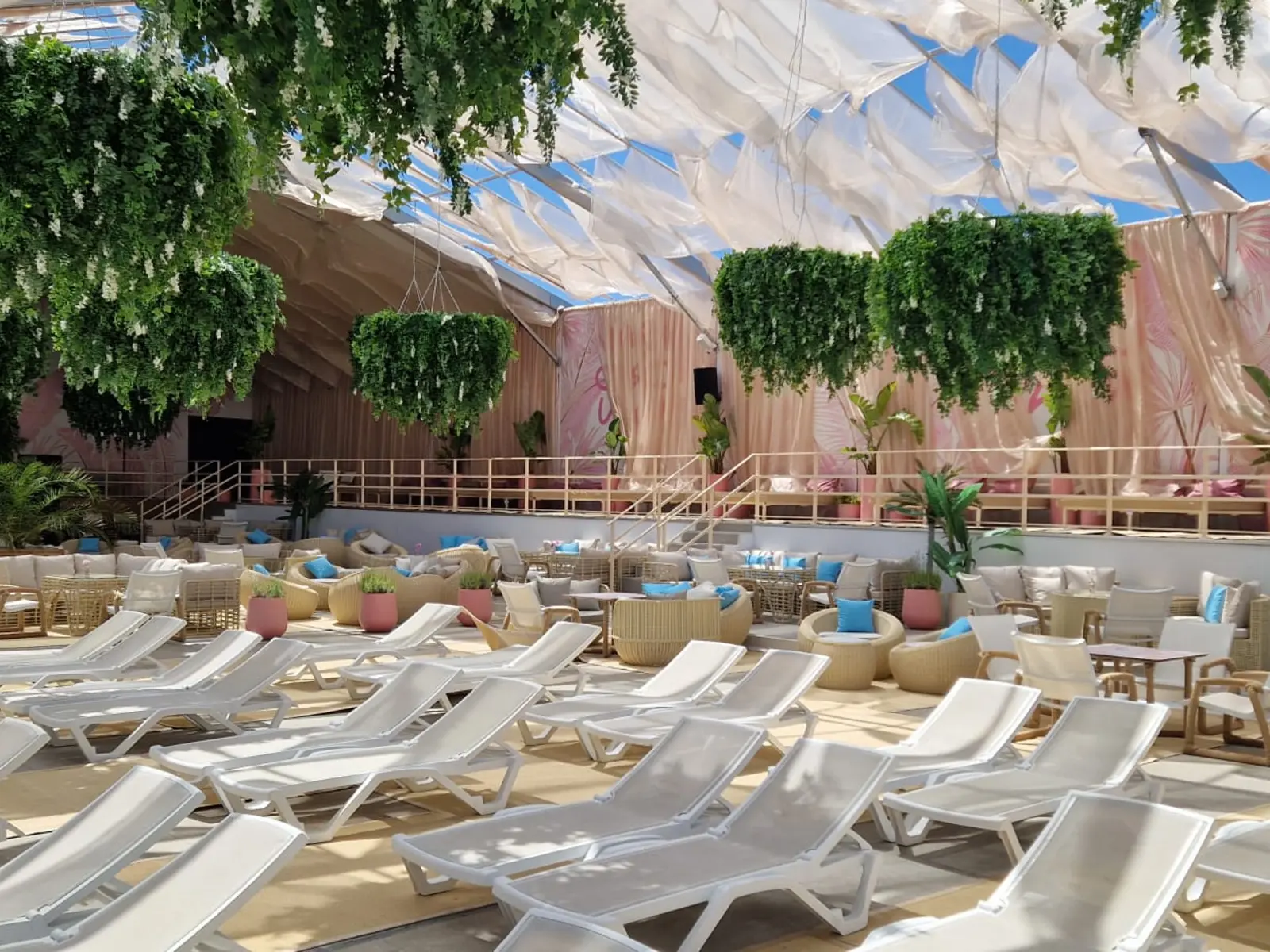 Rows of artificial hanging planters above a commercial seating area in Moldova in 2024