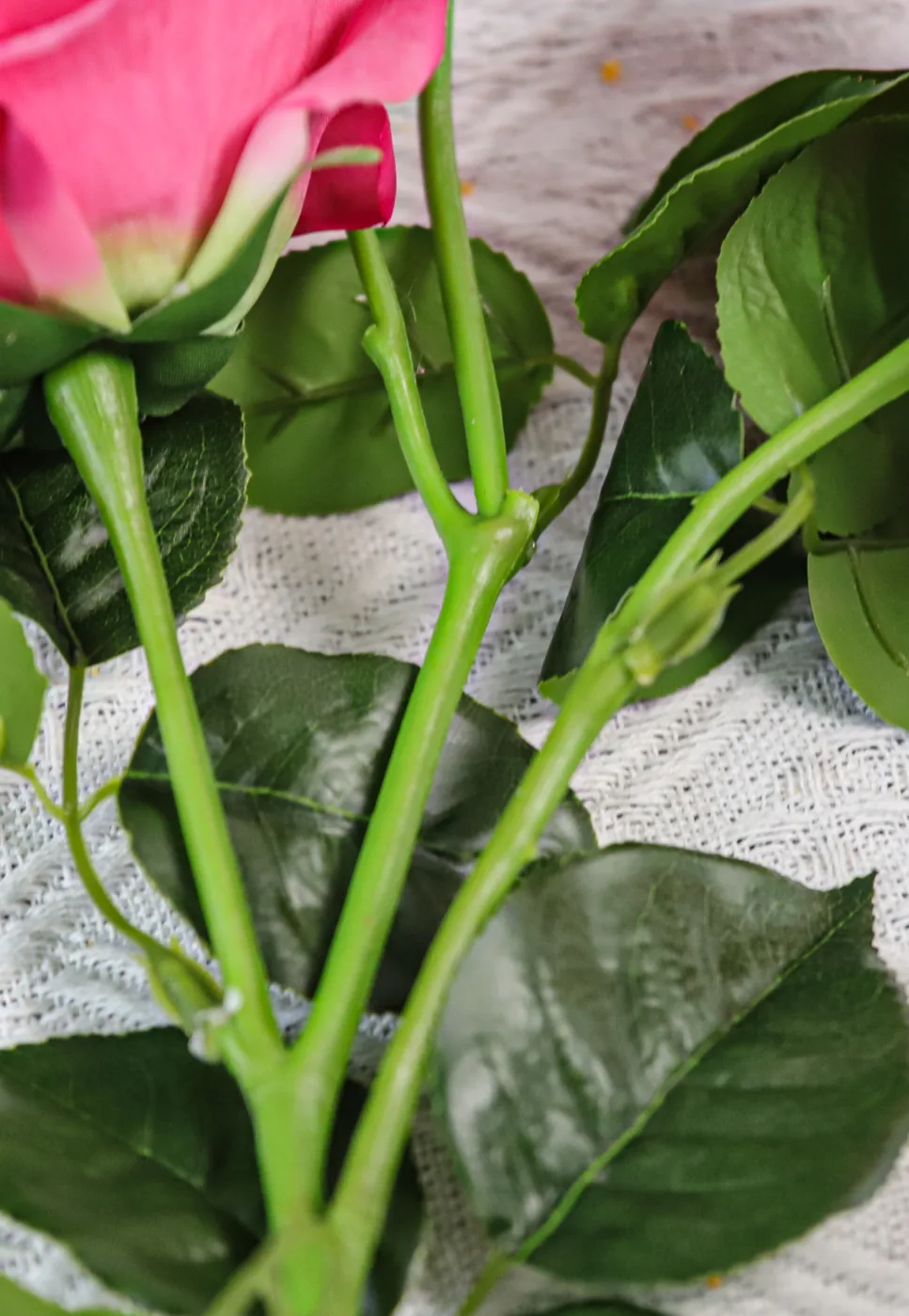 Close-up of artificial rose stems leaves and petal construction