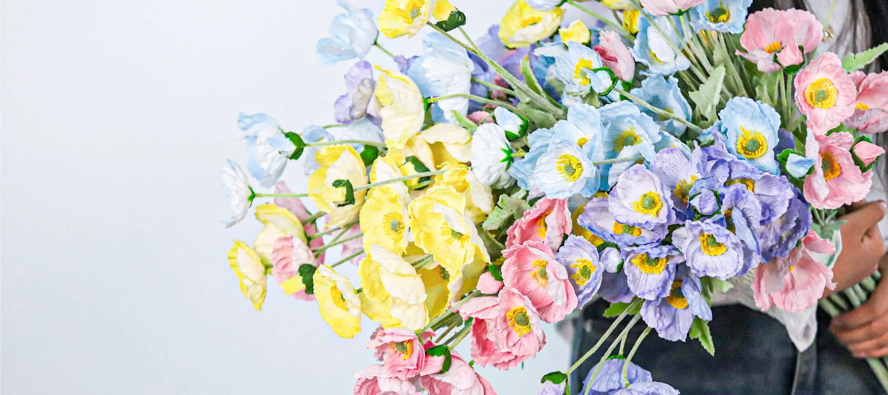 Colourful artificial and silk flowers arranged for commercial interiors and event projects