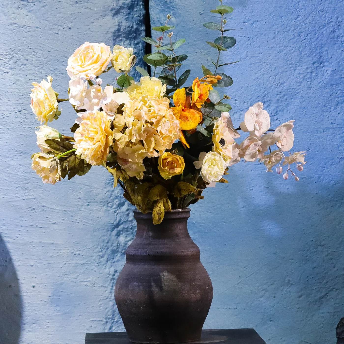 Finished artificial flower composition for a commercial interior
