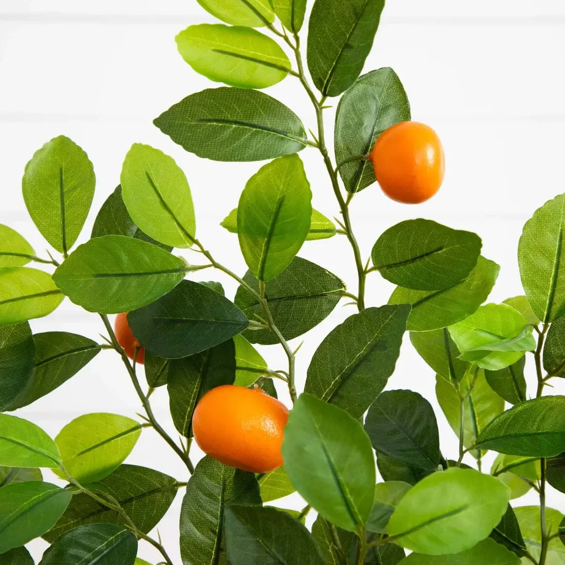 Artificial orange tree branches with varied green leaf colours and orange fruit