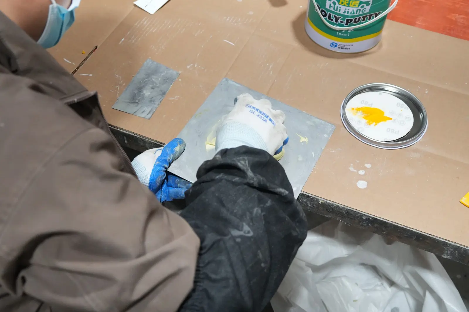 Oakco artisan preparing a custom color mixture for an artificial tree finish