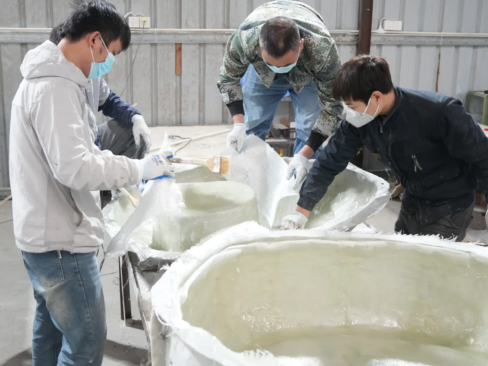 Oakco production team manufacturing large fibreglass components inside the factory