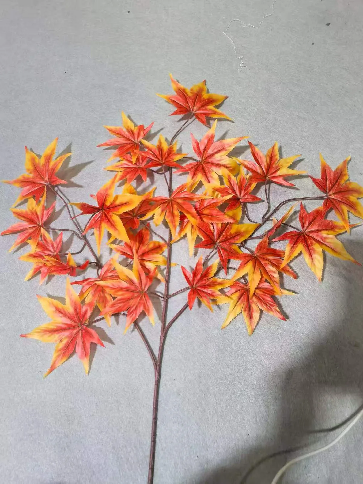 Orange artificial maple leaf spray detail