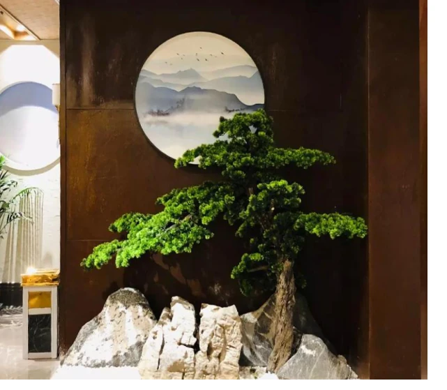 Artificial bonsai tree integrated into an interior landscape installation